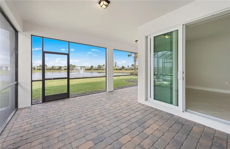 Unfurnished sunroom featuring a water view