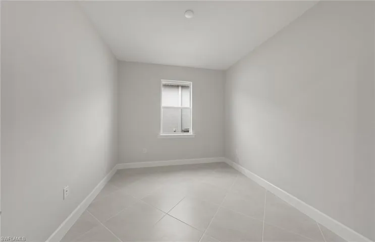 Unfurnished room with light tile patterned floors