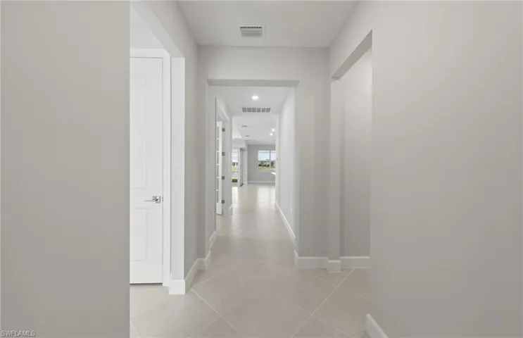 Hallway with light tile patterned floors