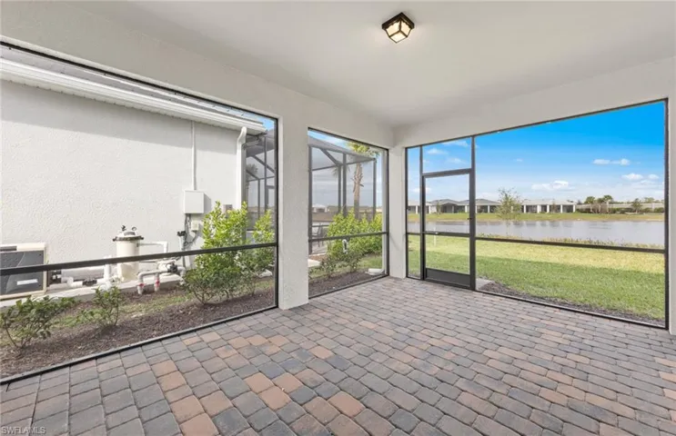 Unfurnished sunroom featuring a water view