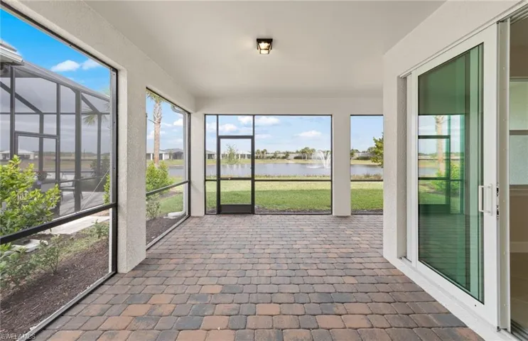 Unfurnished sunroom featuring a water view