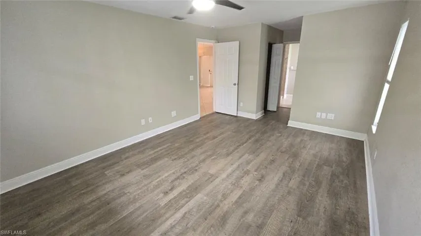 bedroom featuring dark wood finished floors and ceiling fan