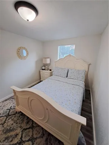Bedroom featuring dark wood-type flooring