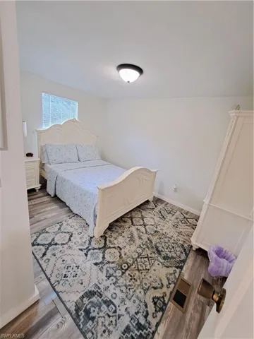 Bedroom with hardwood / wood-style flooring