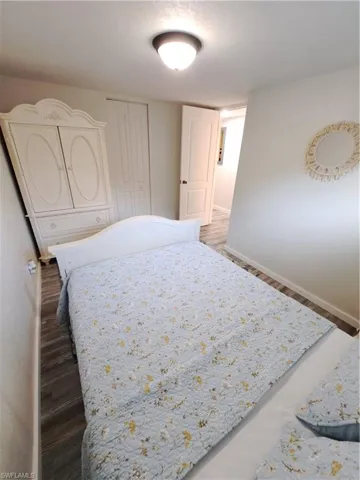 Bedroom featuring dark wood-type flooring