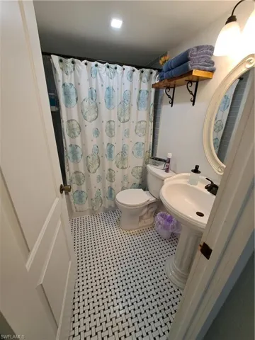 Bathroom with tile flooring and toilet