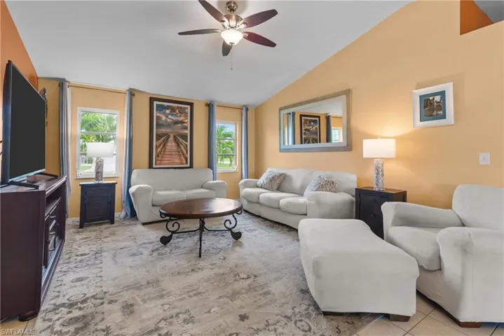 Living area featuring vaulted ceiling