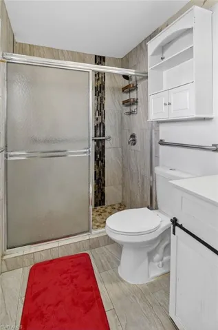 Bathroom featuring a shower stall and vanity