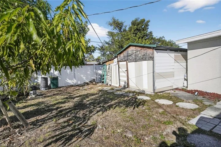 Fenced backyard with a storage unit
