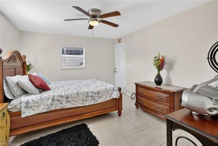 Bedroom with a ceiling fan and light tile patterned floors