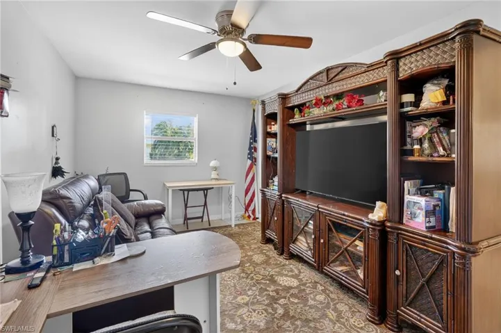 Office with ceiling fan and baseboards