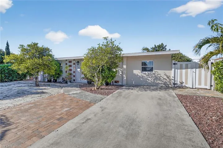 View of front of home featuring stucco siding and concrete driveway