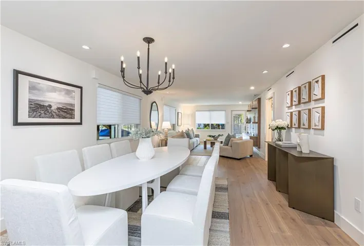 Dining area featuring visible vents, baseboards, light wood-style flooring, a chandelier, and recessed lighting