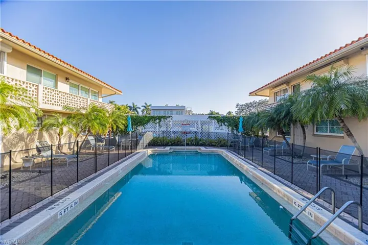 View of swimming pool with fence and a fenced in pool