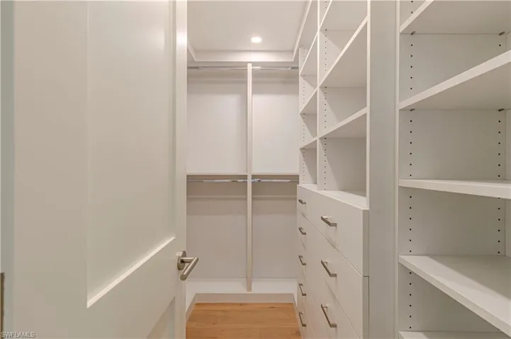 Spacious closet with light wood-style floors