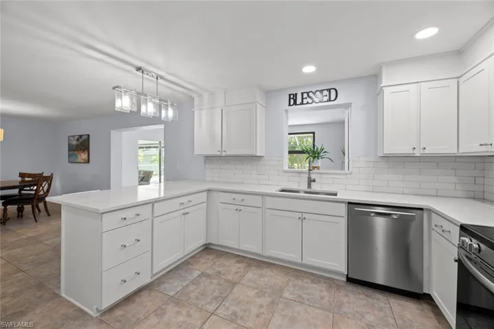 Light and bright kitchen with quartz countertops and shaker cabinets