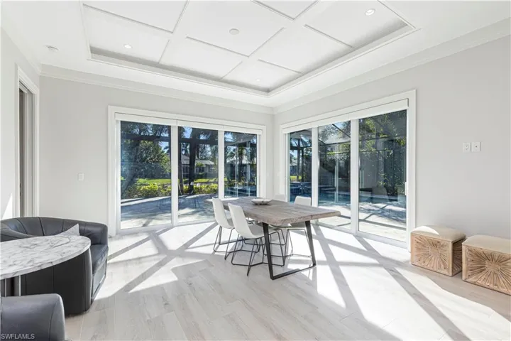 Sunroom featuring beam ceiling and coffered ceiling