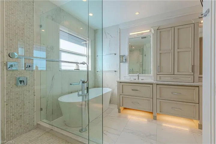 Bathroom with vanity and shower with separate bathtub