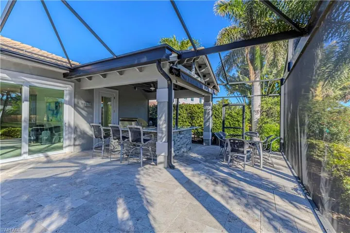 View of patio / terrace with an outdoor bar and a lanai