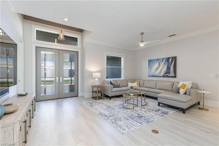 Living room featuring ceiling fan, light hardwood / wood-style flooring, and french doors