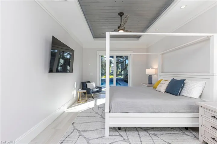 Bedroom with access to exterior, wood ceiling, ceiling fan, crown molding, and light hardwood / wood-style flooring
