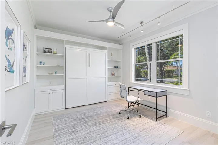 Office featuring ceiling fan and light hardwood / wood-style floors