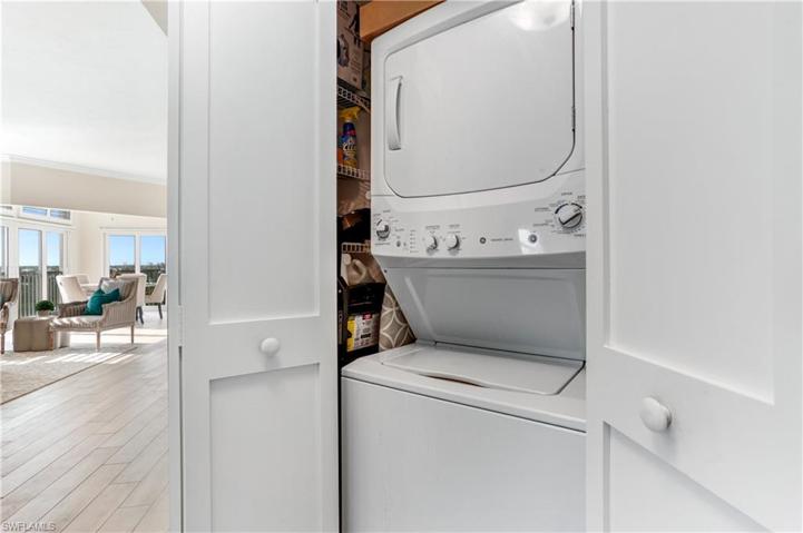 Stackable washer/dryer closet with extra storage.