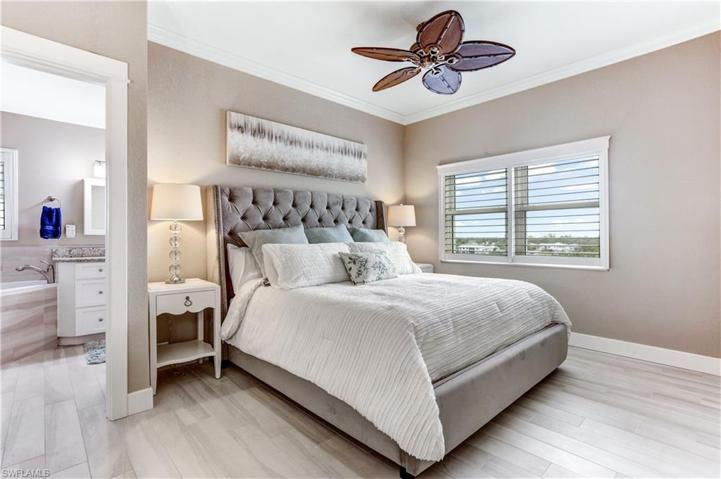 Spacious main bedroom with walk-in closet, plantation shutters, and more bay views!
