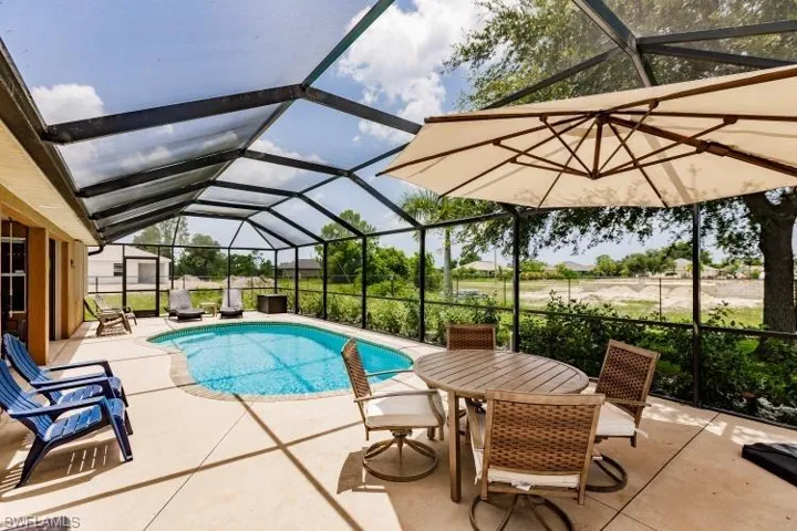 View of pool featuring a patio and a lanai