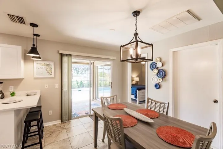 Dining room with a notable chandelier and light tile patterned flooring