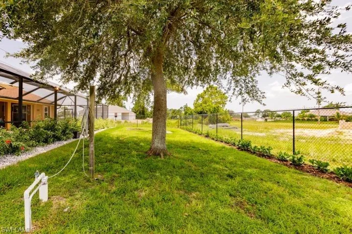 View of yard with a lanai