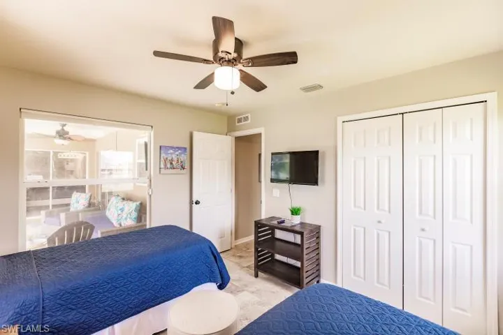 Bedroom with ceiling fan and a closet
