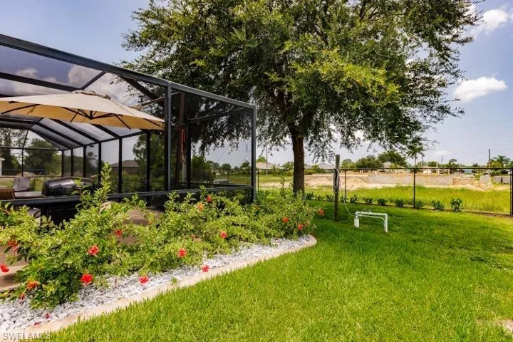 View of yard with glass enclosure