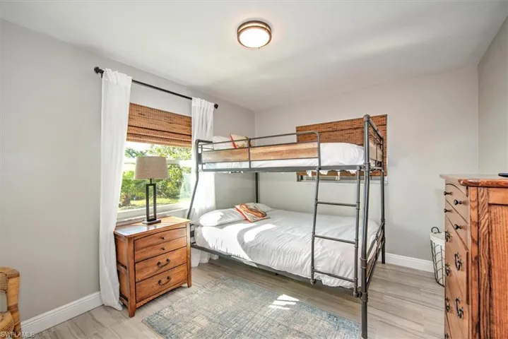 Bedroom with baseboards and light wood-type flooring