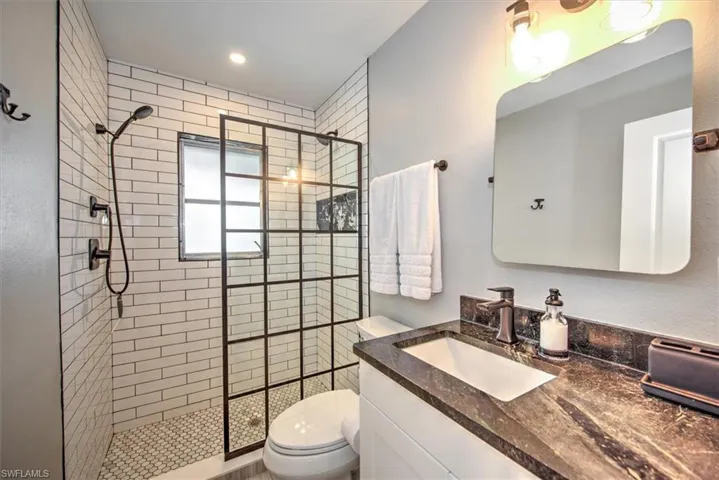 Bathroom featuring vanity, a stall shower, and recessed lighting