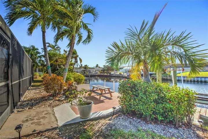 View of yard featuring a water view and a lanai