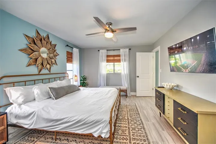Bedroom with a ceiling fan and light wood-style flooring