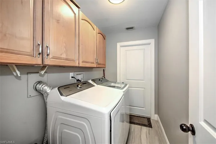 Laundry room with cabinet space and washing machine and clothes dryer