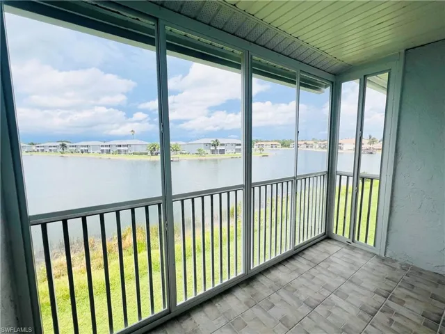 Unfurnished sunroom featuring a water view