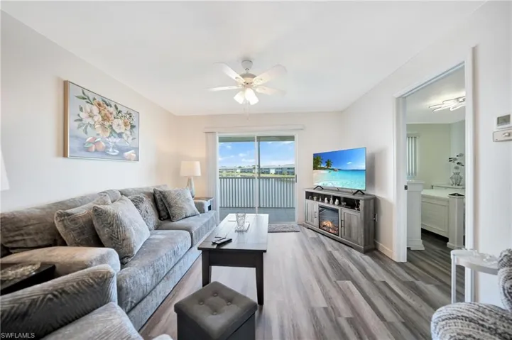 Living room featuring hardwood / wood-style flooring and ceiling fan