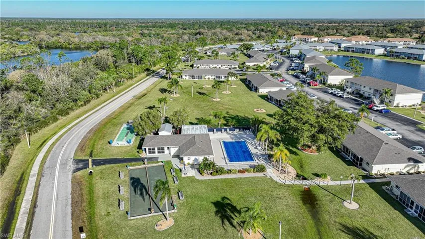 Birds eye view of property with a water view