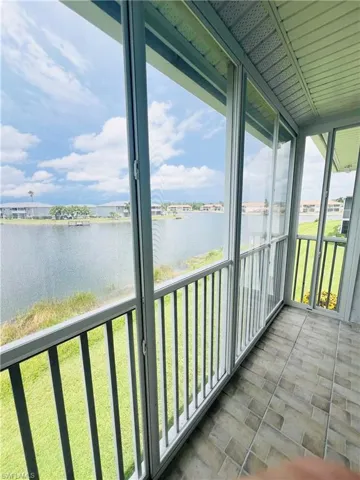 Unfurnished sunroom featuring a wealth of natural light and a water view