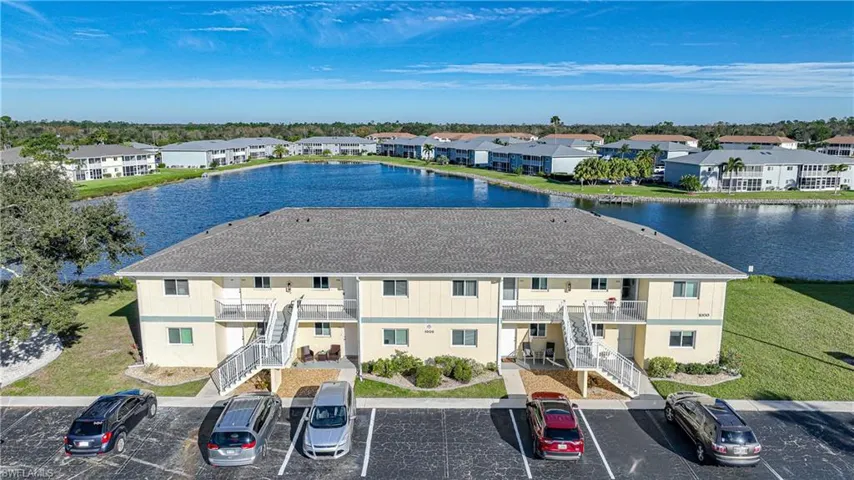 Birds eye view of property with a water view