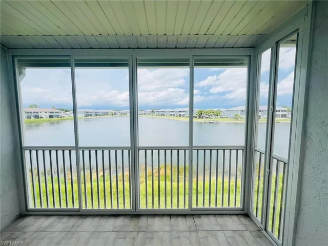 Unfurnished sunroom featuring a water view