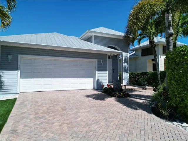 Light gray siding exterior with a metal roof