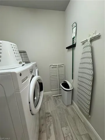 Laundry room featuring separate washer and dryer and baseboards