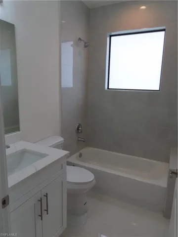Full bath with vanity, shower / bathtub combination, and tile patterned floors