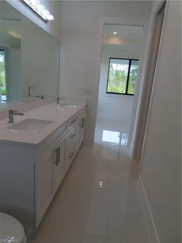 Full bathroom with tile patterned flooring and double vanity