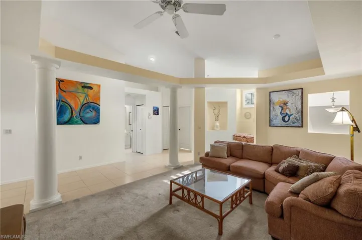Family room with ceiling fan, lofted ceiling