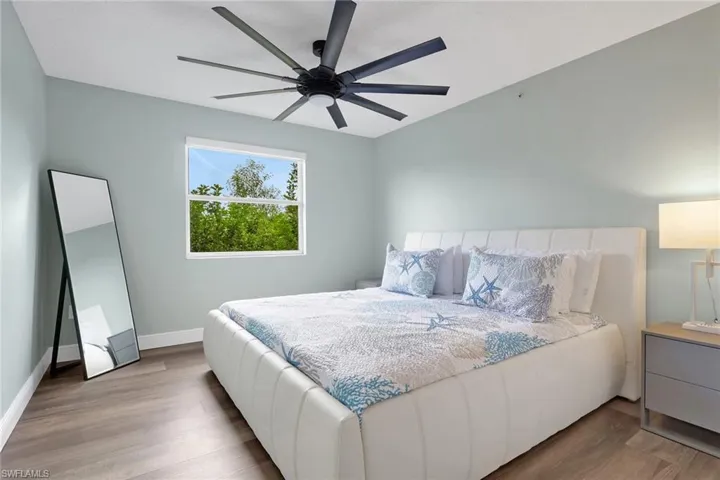 Bedroom featuring wood finished floors and ceiling fan